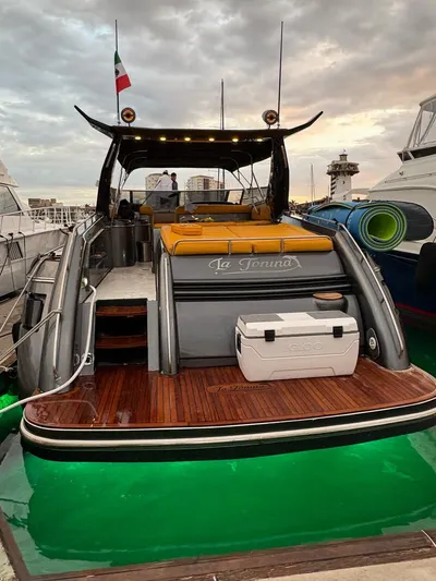  Yacht Photos Pics Sunseeker Predator 58 yacht, 1994 model, docked with illuminated deck and Italian flag.