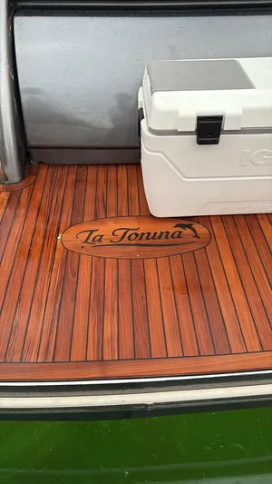  Yacht Photos Pics Teak deck of 1994 Sunseeker Predator 58 with cooler and "La Tonina" emblem.