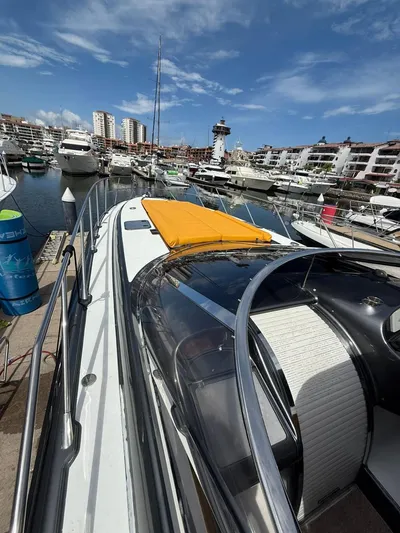  Yacht Photos Pics 1994 Sunseeker Predator 58 yacht docked in a marina under a clear blue sky.