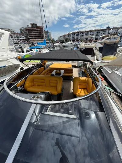  Yacht Photos Pics 1994 Sunseeker Predator 58 yacht with yellow seating, docked in a marina.
