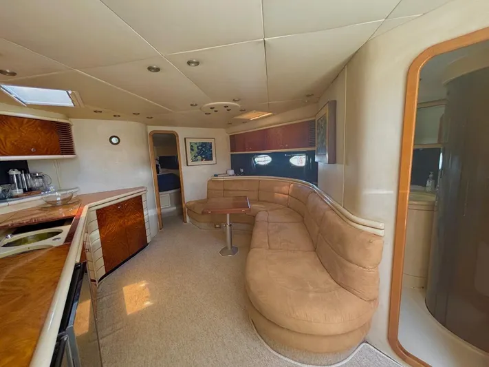  Yacht Photos Pics Luxurious interior of 1994 Sunseeker Predator 58 yacht with plush seating and modern amenities.