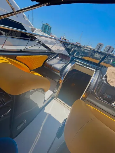  Yacht Photos Pics Interior of a 1994 Sunseeker Predator 58 yacht with yellow seating and modern controls.