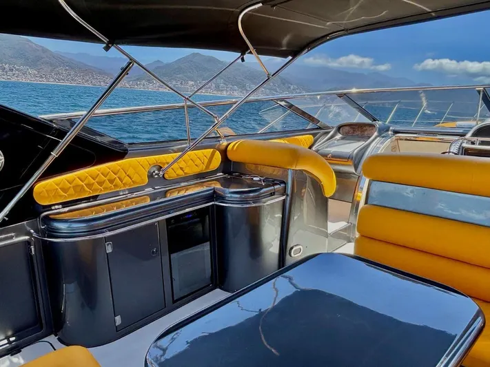  Yacht Photos Pics Luxurious 1994 Sunseeker Predator 58 yacht interior with yellow seating and ocean view.