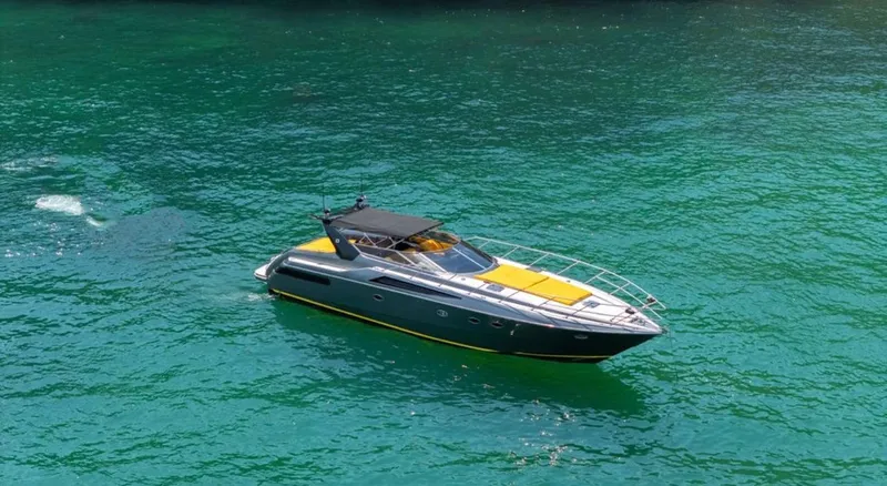  Yacht Photos Pics Sunseeker Predator 58 yacht from 1994 on clear turquoise water.