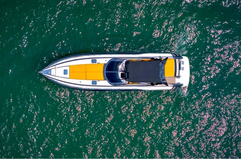  Yacht Photos Pics Aerial view of 1994 Sunseeker Predator 58 yacht on sparkling green water.