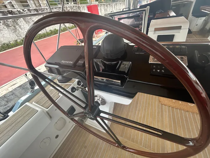 Hindsight Yacht Photos Pics Steering wheel and controls of a 2016 Jeanneau 64 yacht cockpit.