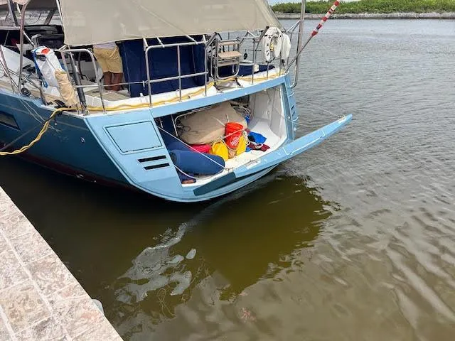 Hindsight Yacht Photos Pics Jeanneau 64 yacht, 2016 model, docked with open storage compartment, displaying boating equipment.