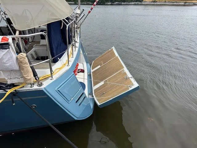 Hindsight Yacht Photos Pics Jeanneau 64 yacht, 2016 model, with open swim platform on calm water.