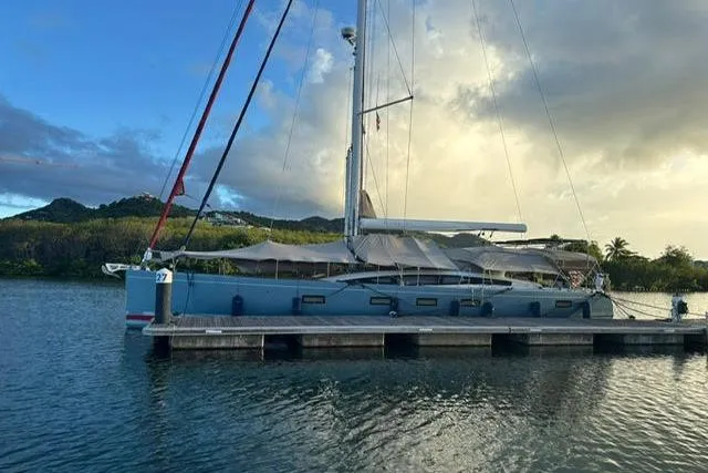 Hindsight Yacht Photos Pics 2016 Jeanneau 64 yacht docked at a serene marina with scenic backdrop.