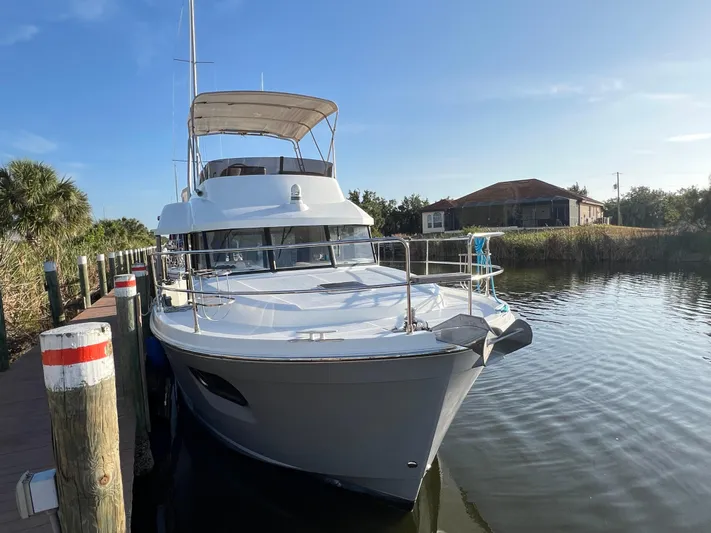 Murfey's Law Yacht Photos Pics 2020 Beneteau Swift Trawler 35 docked by a serene waterfront.