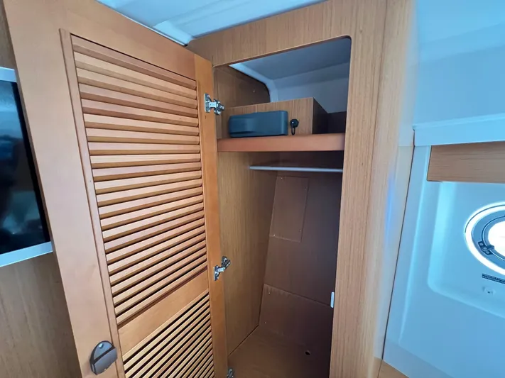 Murfey's Law Yacht Photos Pics 2020 Beneteau Swift Trawler 35 interior closet with wooden louvered door and shelf.