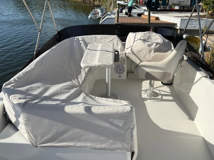 Murfey's Law Yacht Photos Pics 2020 Beneteau Swift Trawler 35 deck with seating and helm, docked by the water.