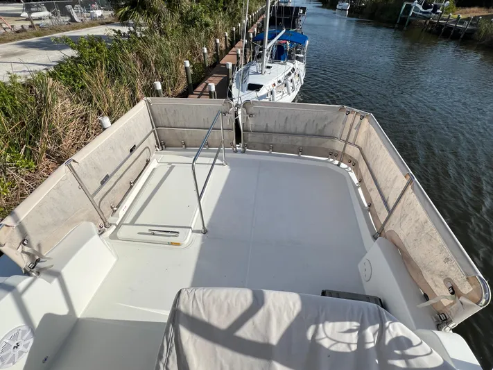Murfey's Law Yacht Photos Pics 2020 Beneteau Swift Trawler 35 flybridge with railing, docked by a canal.