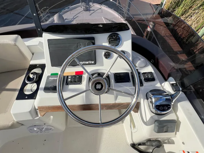 Murfey's Law Yacht Photos Pics 2020 Beneteau Swift Trawler 35 helm with steering wheel and navigation controls.