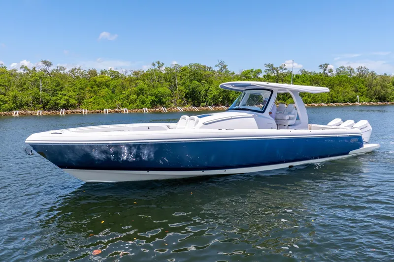  Yacht Photos Pics 2025 Intrepid 41 Panacea boat on water, sleek design, blue and white exterior.