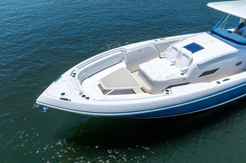  Yacht Photos Pics 2025 Intrepid 41 Panacea luxury boat on calm water, featuring sleek design and spacious deck.