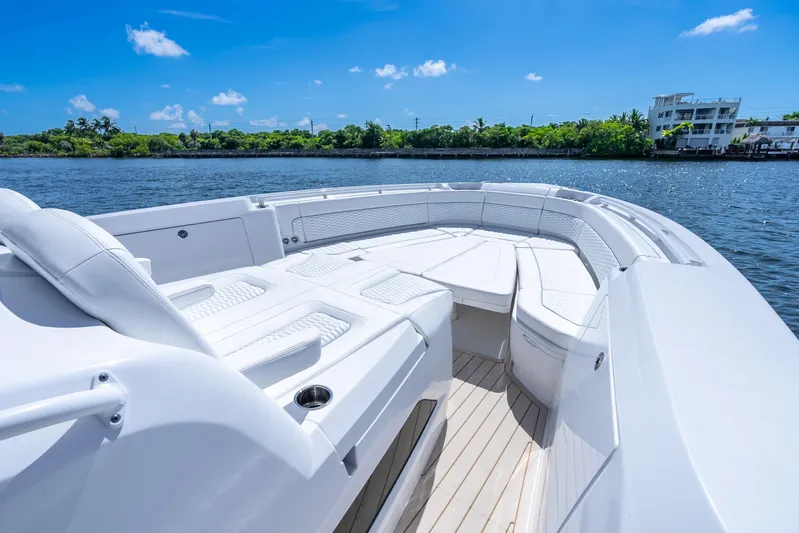  Yacht Photos Pics 2025 Intrepid 41 Panacea boat with luxurious seating on a sunny day.