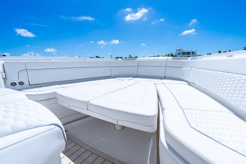  Yacht Photos Pics Luxurious seating on 2025 Intrepid 41 Panacea boat under clear blue sky.