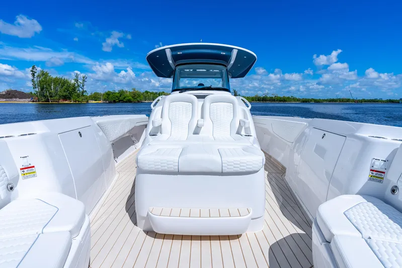  Yacht Photos Pics 2025 Intrepid 41 Panacea boat with luxurious seating on a sunny day.