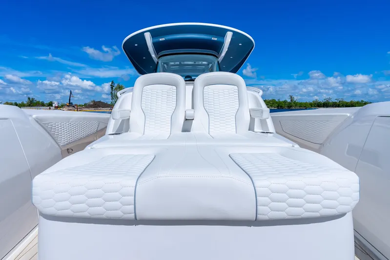  Yacht Photos Pics Luxurious 2025 Intrepid 41 Panacea boat with sleek white seating under a clear blue sky.