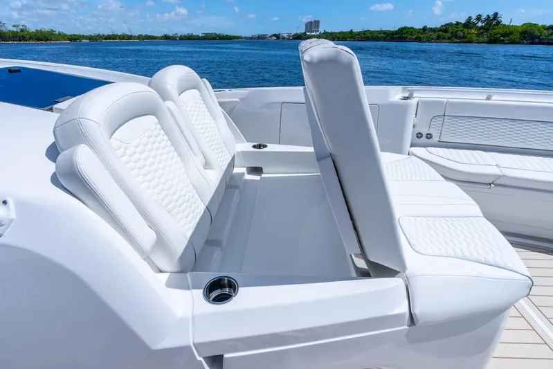  Yacht Photos Pics Luxurious seating on 2025 Intrepid 41 Panacea yacht, featuring white upholstery and ocean backdrop.