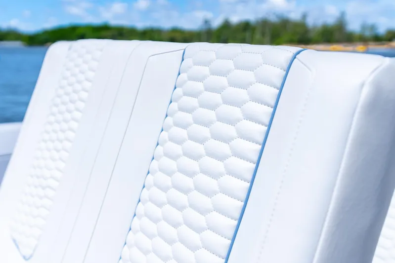  Yacht Photos Pics Luxurious white seating on 2025 Intrepid 41 Panacea boat, featuring hexagonal pattern design.
