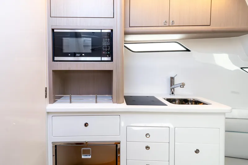  Yacht Photos Pics Modern kitchen area in 2025 Intrepid 41 Panacea yacht with microwave and sink.