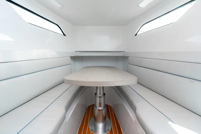  Yacht Photos Pics Interior of 2025 Intrepid 41 Panacea boat with sleek seating and table.