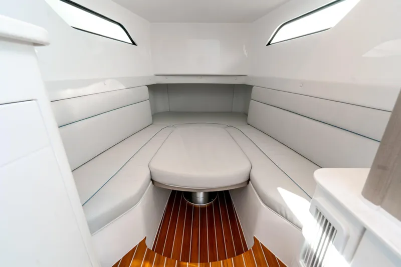  Yacht Photos Pics Luxurious interior of 2025 Intrepid 41 Panacea boat with sleek seating and wood flooring.