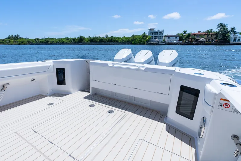  Yacht Photos Pics 2025 Intrepid 41 Panacea boat deck with triple Mercury engines, on a sunny day.