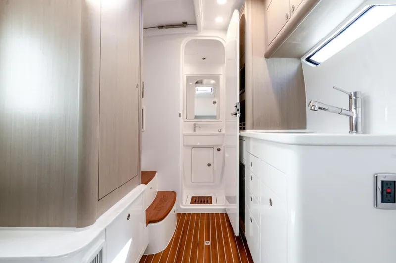  Yacht Photos Pics Luxurious interior of 2025 Intrepid 41 Panacea boat with modern cabinetry and fixtures.