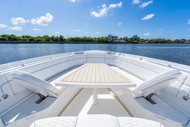  Yacht Photos Pics Luxurious seating area on 2025 Intrepid 41 Panacea yacht, with scenic waterfront view.