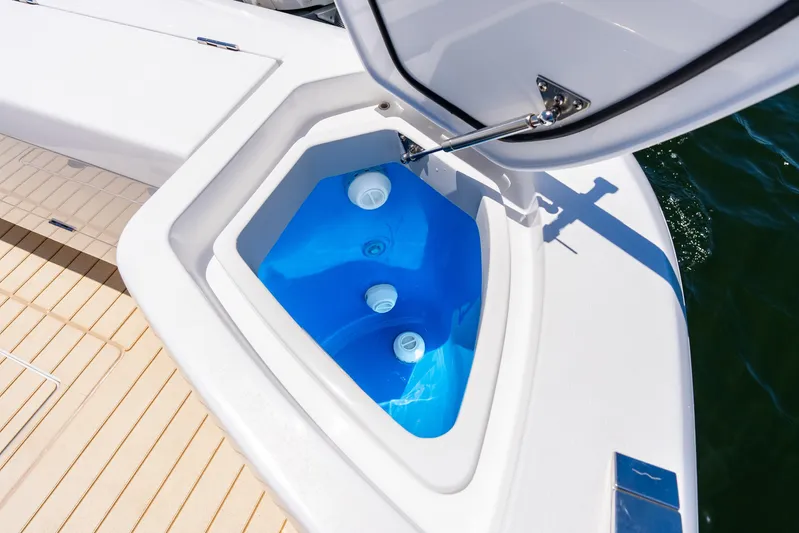  Yacht Photos Pics Livewell compartment on 2025 Intrepid 41 Panacea boat, open with blue interior.