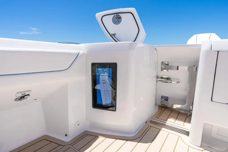  Yacht Photos Pics 2025 Intrepid 41 Panacea boat interior with open storage compartment, sleek design, and blue sky.