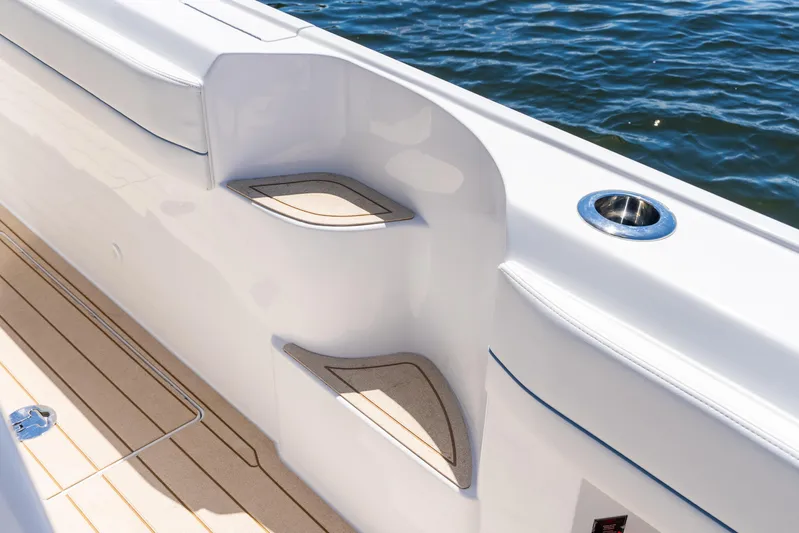  Yacht Photos Pics 2025 Intrepid 41 Panacea boat interior with sleek design and cup holder by the water.