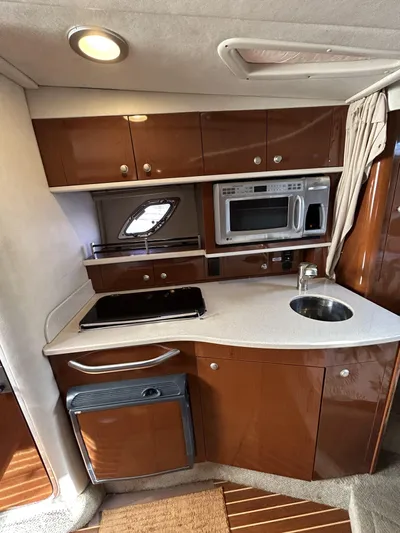 Andrew's Place Yacht Photos Pics 2009 Sea Ray 310 Sundancer galley with microwave, sink, and storage cabinets.