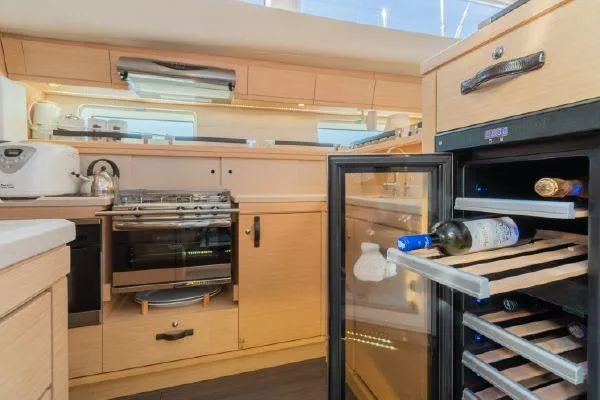 Hindsight Yacht Photos Pics Modern kitchen in 2016 Jeanneau 64 yacht with wine cooler and stainless steel appliances.