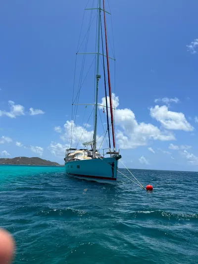 Hindsight Yacht Photos Pics 2016 Jeanneau 64 sailboat anchored in clear blue tropical waters.