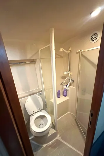 Tracy II Yacht Photos Pics Compact bathroom in a 2002 Riviera 350 boat, featuring a toilet and shower.