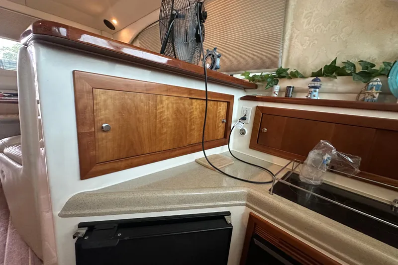 Tracy II Yacht Photos Pics Interior of a 2002 Riviera 350 yacht with wooden cabinetry and countertop.