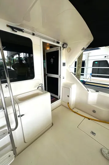 Tracy II Yacht Photos Pics 2002 Riviera 350 yacht interior with sink and stairs, showcasing sleek design.