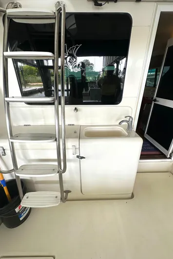 Tracy II Yacht Photos Pics 2002 Riviera 350 yacht interior with ladder and sink area.