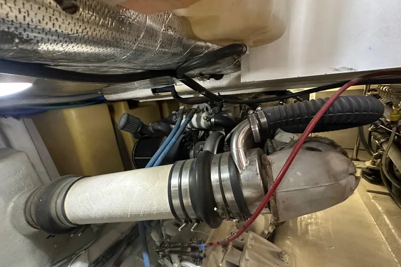 Tracy II Yacht Photos Pics Engine compartment of a 2002 Riviera 350 boat, showcasing exhaust and ventilation components.