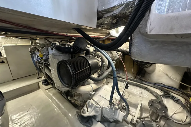 Tracy II Yacht Photos Pics Engine room of a 2002 Riviera 350 boat, showcasing mechanical components and wiring.