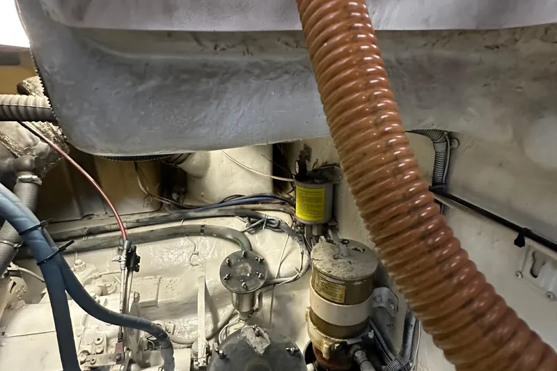 Tracy II Yacht Photos Pics Engine room of a 2002 Riviera 350 boat, showing hoses and mechanical components.