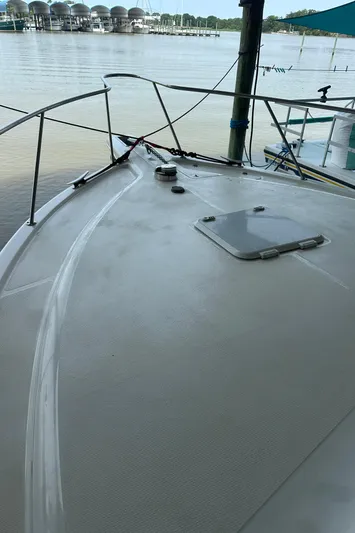 Tracy II Yacht Photos Pics 2002 Riviera 350 boat deck with railing, docked by calm waters.