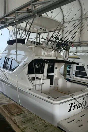 Tracy II Yacht Photos Pics 2002 Riviera 350 yacht docked, featuring fishing rods and spacious deck.