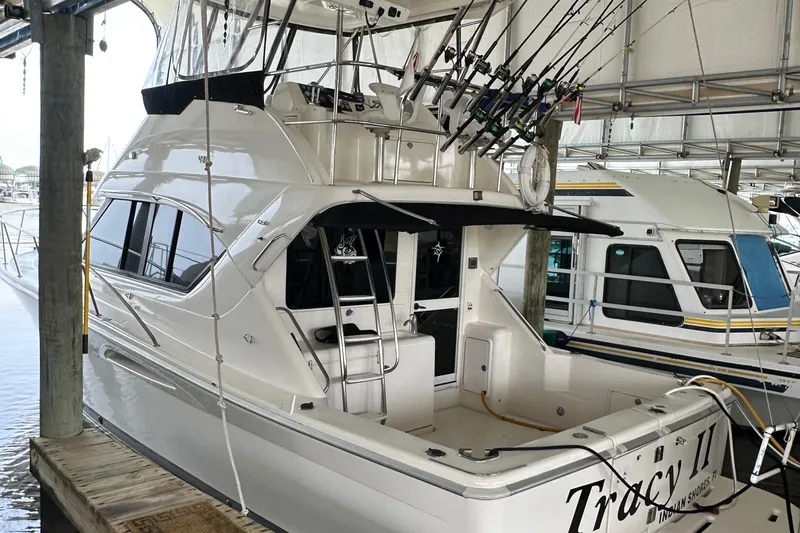 Tracy II Yacht Photos Pics 2002 Riviera 350 yacht docked, featuring fishing rods and spacious deck area.