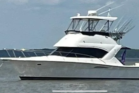 Tracy II Yacht Photos Pics 2002 Riviera 350 yacht on calm waters with fishing rods.