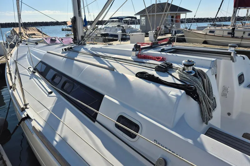 Serene Yacht Photos Pics 2011 Beneteau Oceanis 37 sailboat docked at marina, showcasing sleek design and rigging.